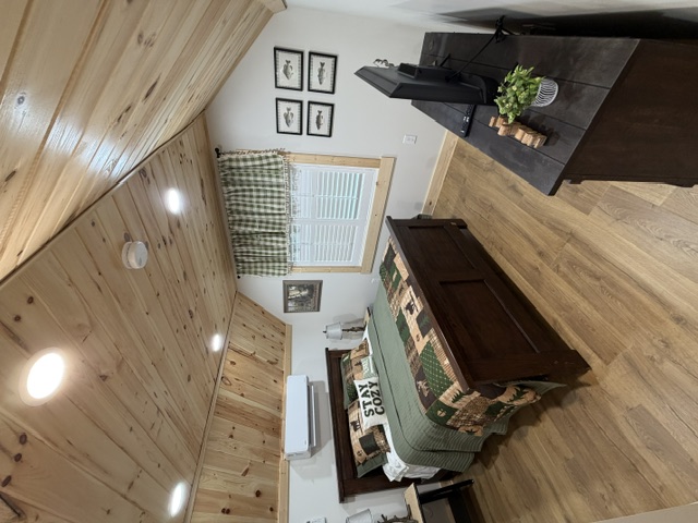 Queen bedroom beneath a wood ceiling