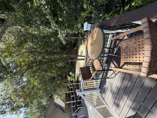 Deck seating overlooking the wooded yard
